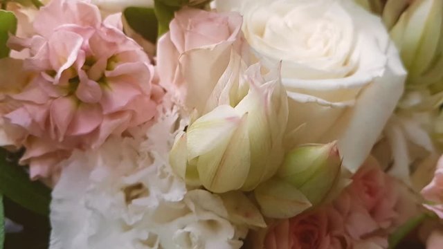 Beautiful delicate video sequence: a neat bride's bouquet in pink and dimmed lights. Festive atmosphere. Romantic screensaver background. Gift for birthday, anniversary, Valentine's day, mother's day.