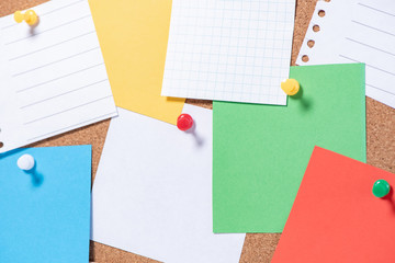 Corkboard for notes with empty sheets on buttons closeup