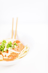 Italian pasta with chopsticks, tomato sauce, parmesan cheese, fresh oregano and basil - on white background.