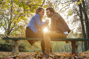 Couple in the park enjoying nice autumn time.