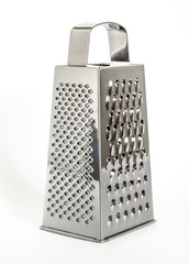 shiny metal new grater isolated on white background, close-up cheese and food grater