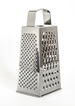 shiny metal new grater isolated on white background, close-up cheese and food grater
