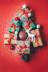 Christmas tree made presents and ornaments on a red background