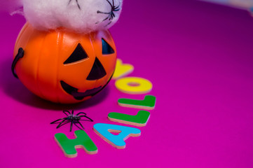 Halloween message made with letters between a pumpkin.