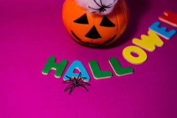 Halloween message made with letters between a pumpkin.