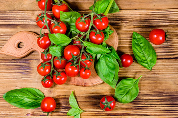 Heap of small cherry tomatoes on wooden table. Top view