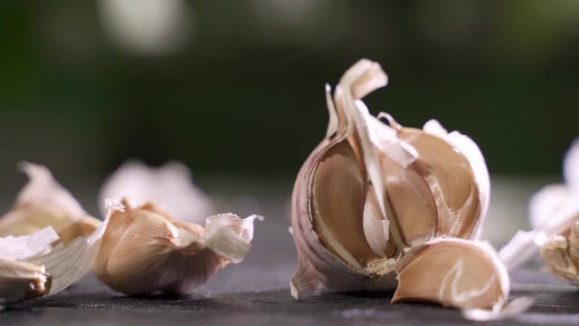 Whole garlic bulbs and garlic skin is blown away.