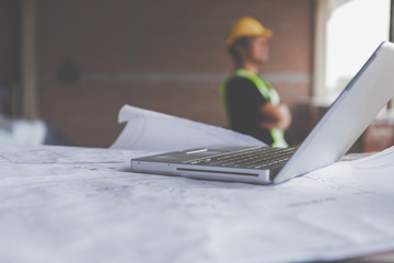 Consultant engineer discussing construction project in blueprint; Consulting concept in...