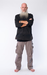 Fototapeta premium Full body shot of mature bald bearded man with arms crossed