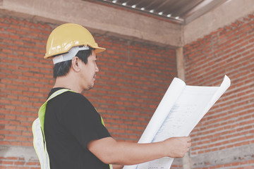 Consultant engineer discussing construction project in blueprint; Consulting concept in...