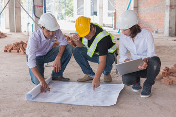 Consultant engineer discussing construction project in blueprint; Consulting concept in...