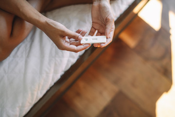 Close up of woman holding pregnancy test