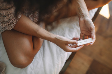 Close up of woman holding pregnancy test