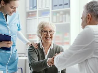Doctor giving an handshake to a senior patient