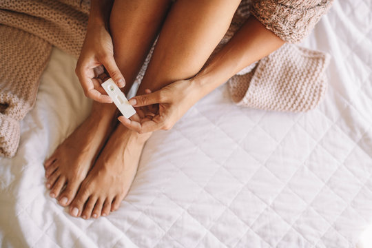 Woman holding pregnancy test