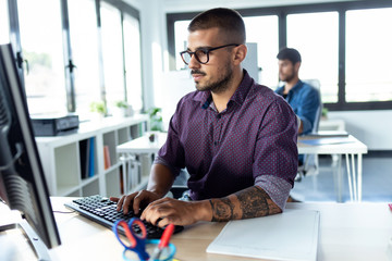 Software developer working with computer in the modern startup office.