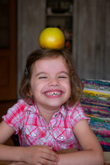 Fototapeta premium Target concept - little kid girl with the apple on the head