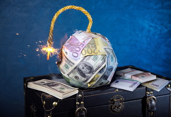 Financial crisis.The world of money is burning.Financial capital bomb explodes.Smoke,fuse.Dollar and Euro decrease. Global economic recession and  stock exchange crash concept.
