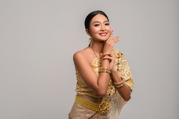Women wearing Thai clothes and hands touching their faces