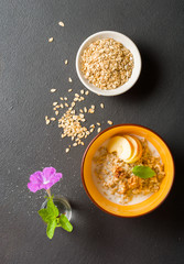 morning oatmeal for breakfast. Early morning and healthy diet food. Proper nutrition. Dark stone background. Plenty of space for text.