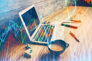 Double exposure of graph and financial info and work space with computer background. Concept of...