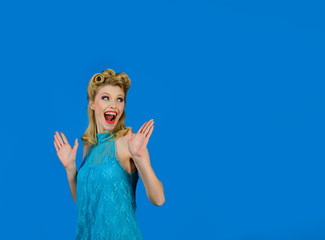 Pin-up girl. Retro fashion and vintage concept. Smiling woman dressed in pin-up style. Expressive facial expressions. Smiling retro girl. Emotional girl. Smiling woman with clean skin, bright make-up.
