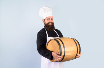 Brewery for maturing alcohol. Wooden barrel of beer. Celebration oktoberfest festival. Bearded cook with wooden barrel of beer. Beer in Germany. Barman. Equipment for preparate of beer. Homemade wine.