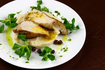 mashed potatoes with chicken breast and herbs in a sauce with berries
