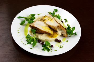 mashed potatoes with chicken breast and herbs in a sauce with berries