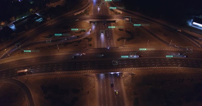Self autonomous unmanned Cars driving on night crossroads Aerial view. Vehicles connected to Future transportation network. Internet of things and Artificial intelligence concept.