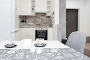 Minimalist modern living room in loft style flat. Modern loft with kitchen and living room, open space interior in Scandinavian style with furniture. Real photo