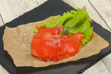 Sliced salmon fillet served rosemary