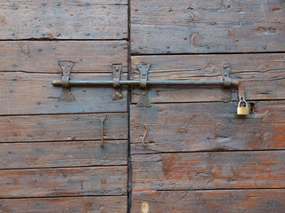 old wooden door on the wall of an italian house