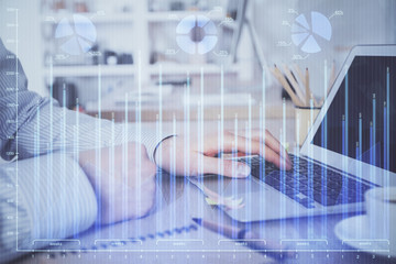 Obraz premium Multi exposure of stock market chart with man working on computer on background. Concept of financial analysis.