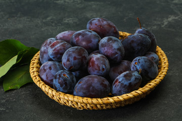 Ripe plum heap in the basket