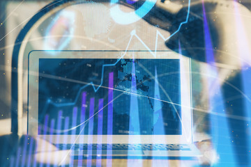 Forex market chart hologram and personal computer background. Double exposure. Concept of investment.