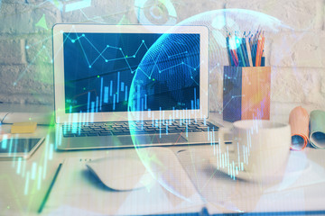 Financial graph colorful drawing and table with computer on background. Double exposure. Concept of international markets.