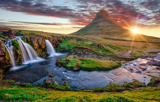 Beautiful landscape with sunrise on Kirkjufellsfoss waterfall and Kirkjufell mountain, Iceland, Europe.