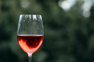 Wineglass with rose wine inside. Copy Space for Text.