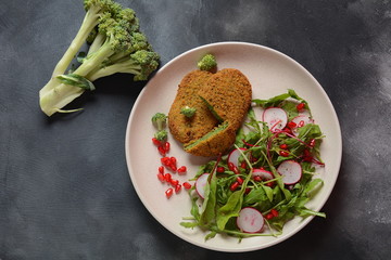 Broccoli schnitzel served with pomegranate salad. Healthy vegan food . Low -fat diet