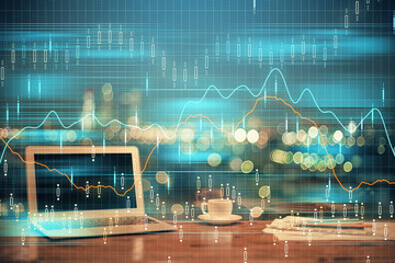 Double exposure of graph and financial info and work space with computer background. Concept of...