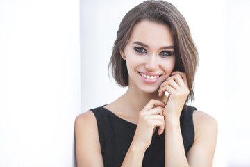 Closeup portrait of attractive young woman on neutral background. Beautiful female outdoors.