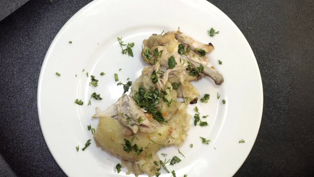 Decorating the pasta dish called in caucasus cuisine puff khinkal with greens and paprika. Overhead shot