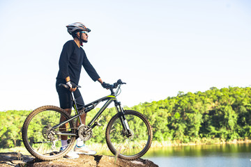 Athletes standing on the mountains with bicycle