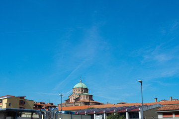 Church of Sacred Hearth of Bologna, Italy as aseen by afar, with blue sky.
