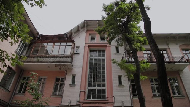 Old building with large windows in the old courtyard.