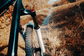 Mountain bike background. Mtb front wheel and fork close-up