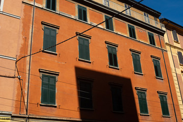 Fototapeta na wymiar Orange Building in Bologna, Italy with blue sky in the background.