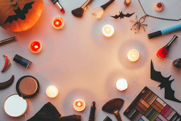 Photo of shadows, brushes, halloween spider, ghost, candles on blank black background.