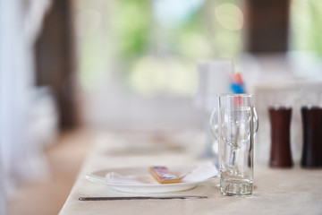 Plates with glasses on a table with a white tablecloth